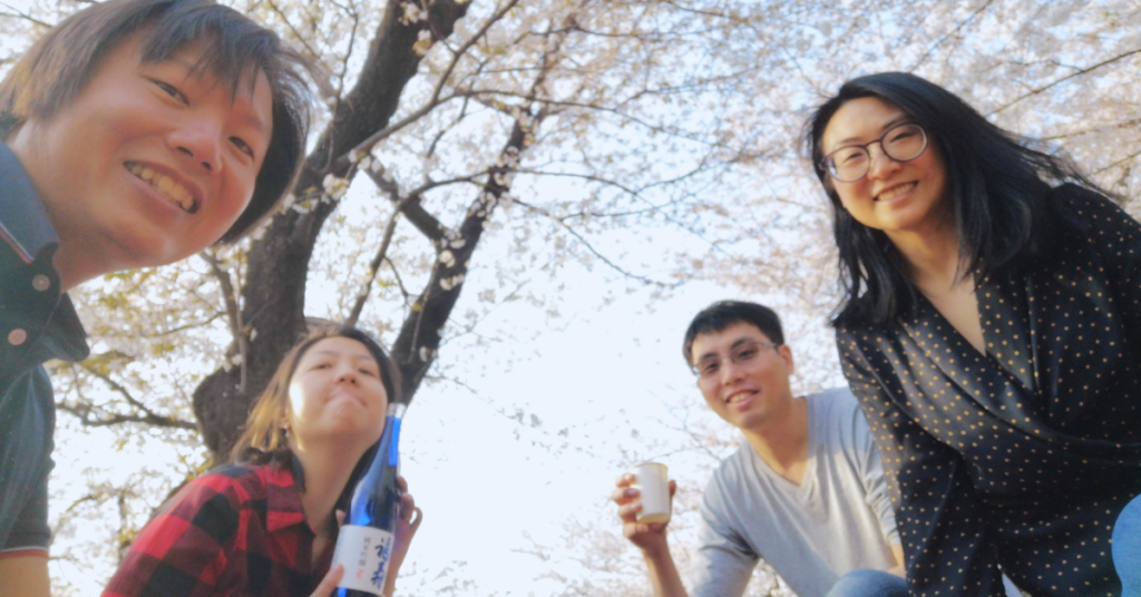 Celebrating friendship while drinking under sakura trees